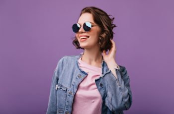 appealing-young-woman-sparkle-sunglasses-looking-distance-portrait-glamorous-european-model-with-short-haircut-smiling